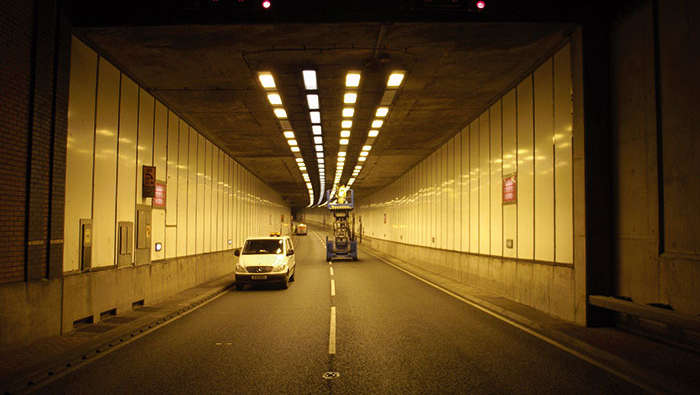 Workers inside a tunnel maintaining the lighting