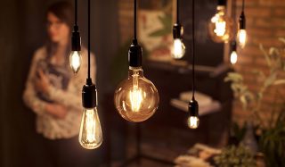 "Vintage-style LED filament bulbs in assorted shapes illuminate dining area, creating warm ambiance and showcasing energy-efficient, decorative lighting solutions for modern home interiors."